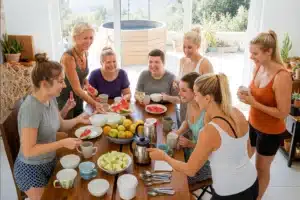 Pros and Cons of Solo vs Group Travel: What’s Right for You? 10 “Group of young travelers eating together”