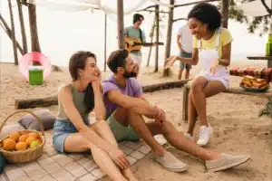 How to Make Friends While Traveling: 9 Easy Ways to Connect in 2026 5 “Backpackers socializing in a hostel lounge”