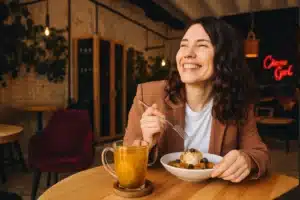 Pros and Cons of Solo vs Group Travel: What’s Right for You? 6 “Solo traveler dining at a local restaurant”