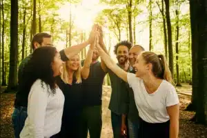 Pros and Cons of Solo vs Group Travel: What’s Right for You? 12 friends high-fiving after a hike in the woods